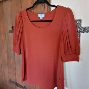 orange top puff sleeve cute for fall with jeans!